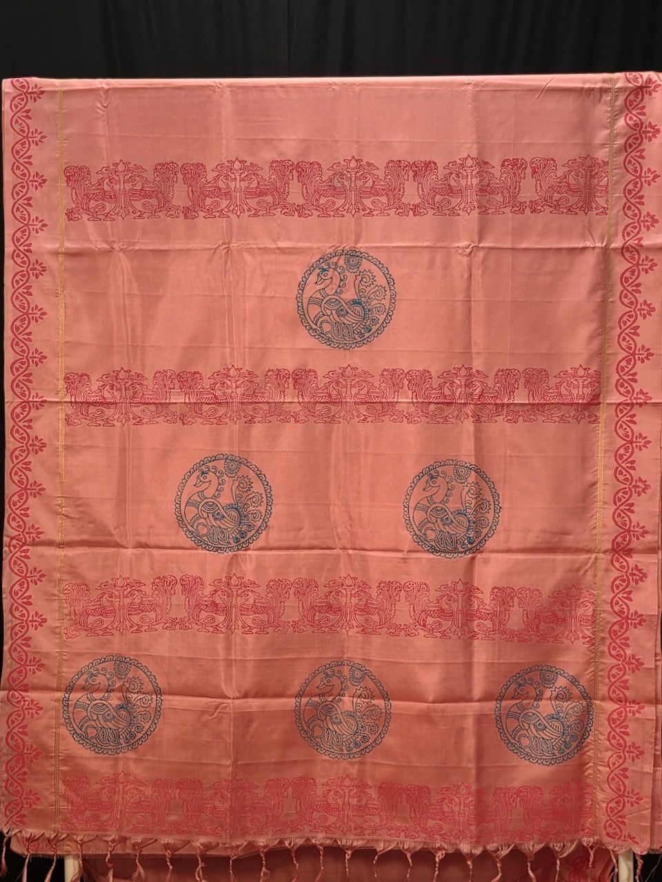 Block Printed Kanjivaram Silk Saree 002 — Beautiful Pink single warp Kanjivaram Silk Saree, Pallu is block printed with Drak Blue Peacock motif, Saree body is printed with small flower motifs and border has Dark Pink creeper prints. Saree comes with same color blouse that has same border prints in green color.