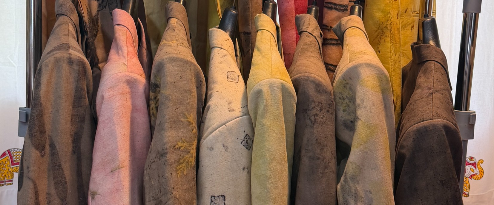 Row of hand block-printed fabrics hanging in warm natural light