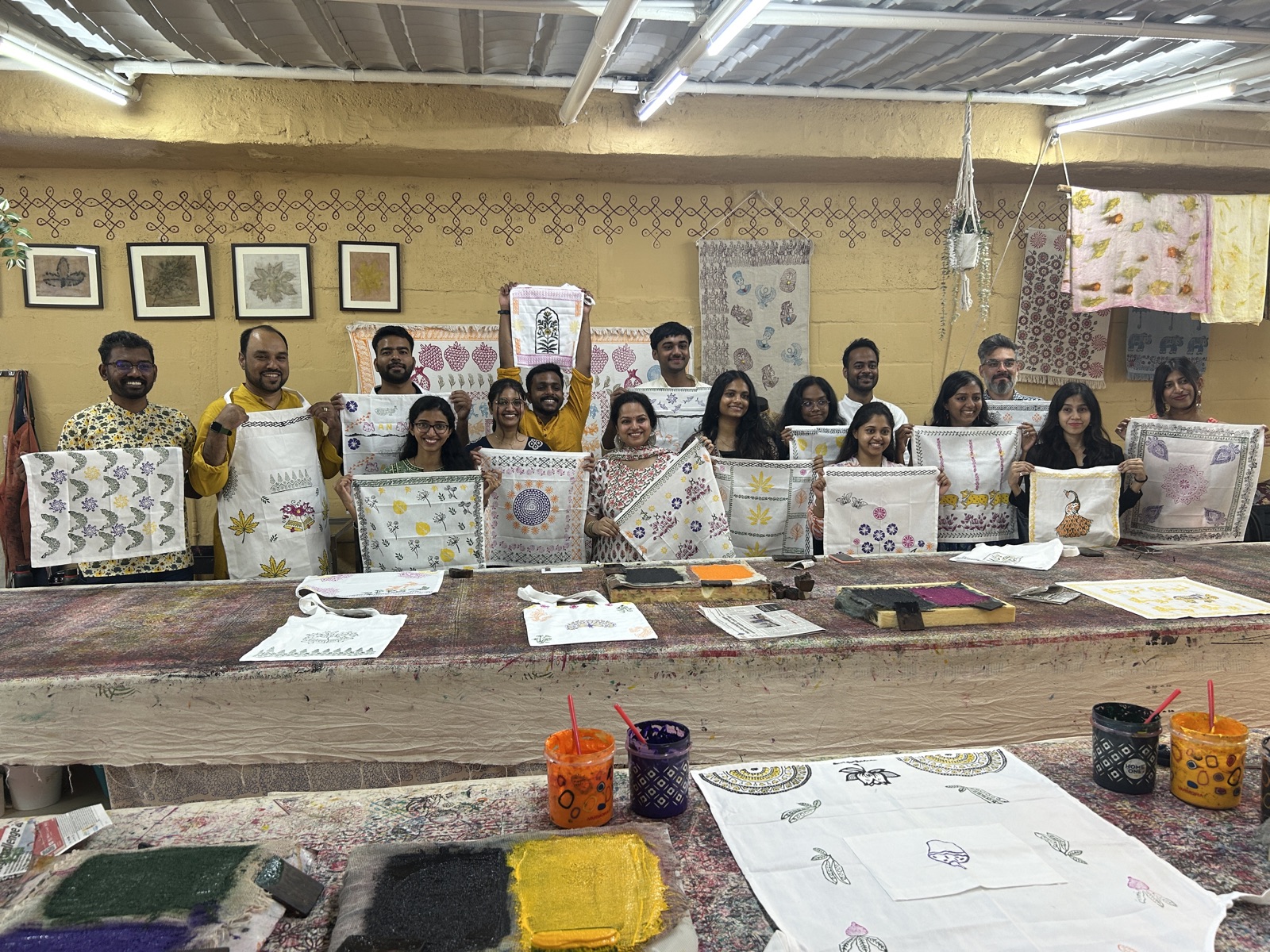 Artisan demonstrating block printing technique on natural fabric